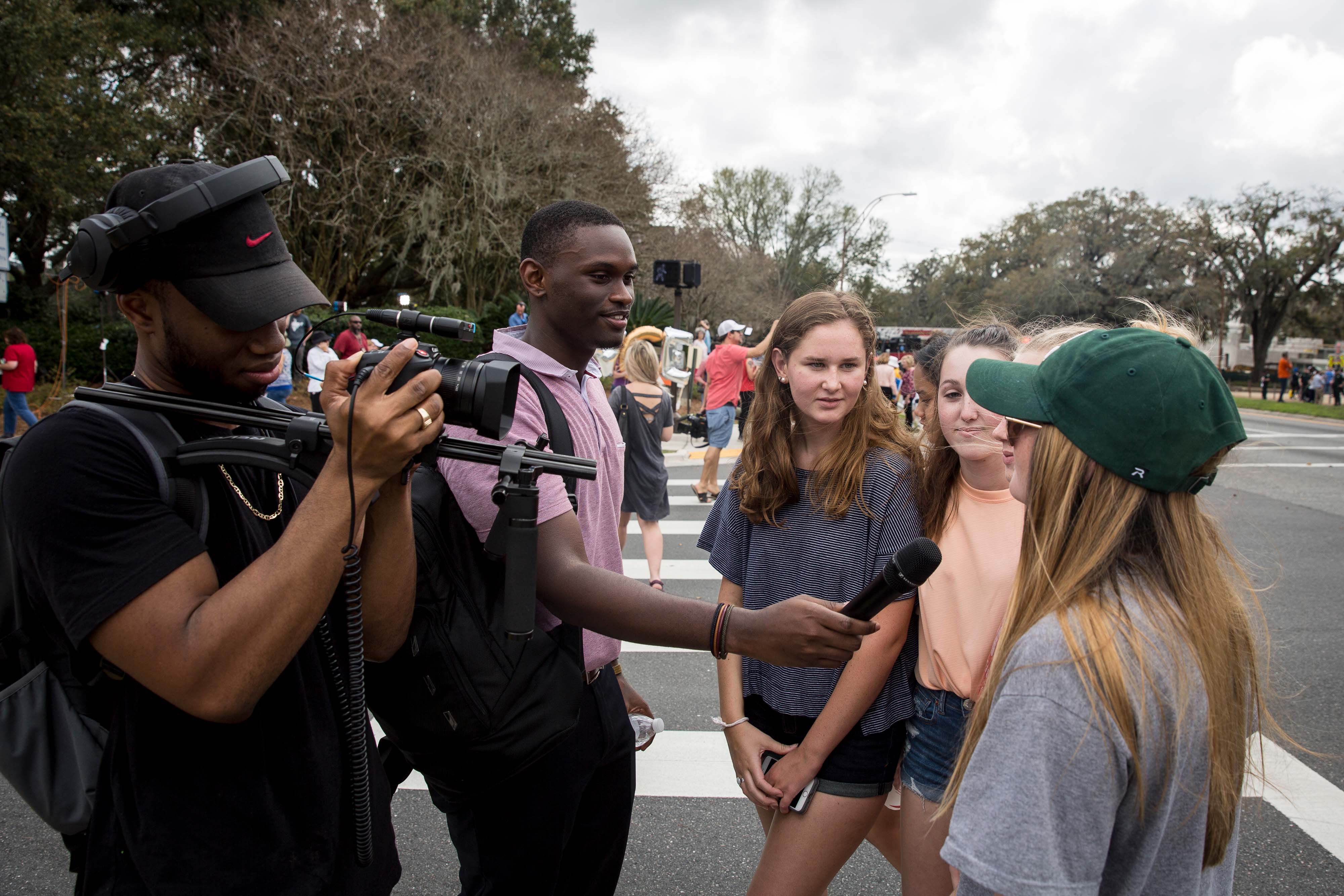 Broadcast Journalism Student interviewing students outside the Florida Capitol building after a march. 