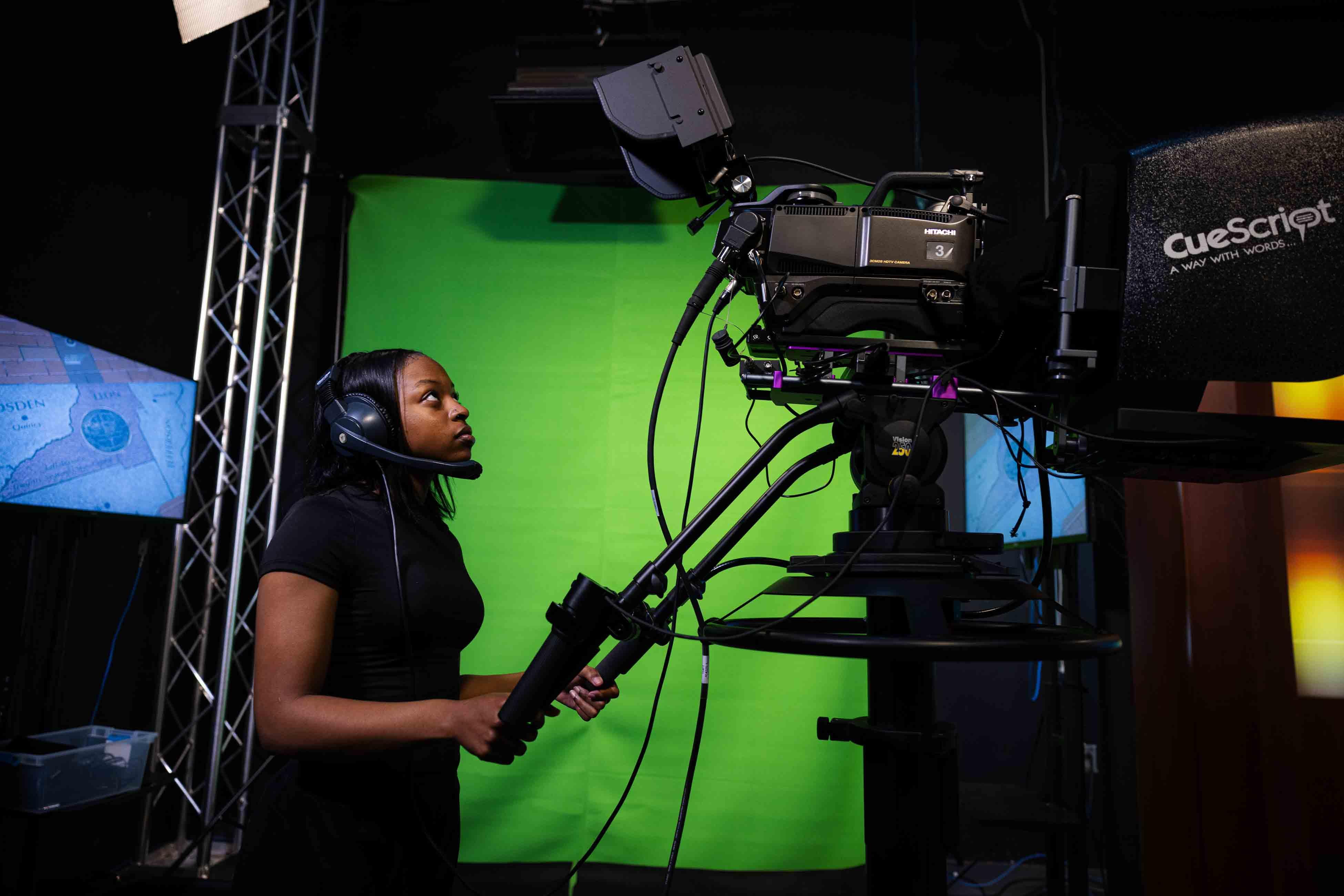 Journalism Student operating a camera in the TV-20 studio.