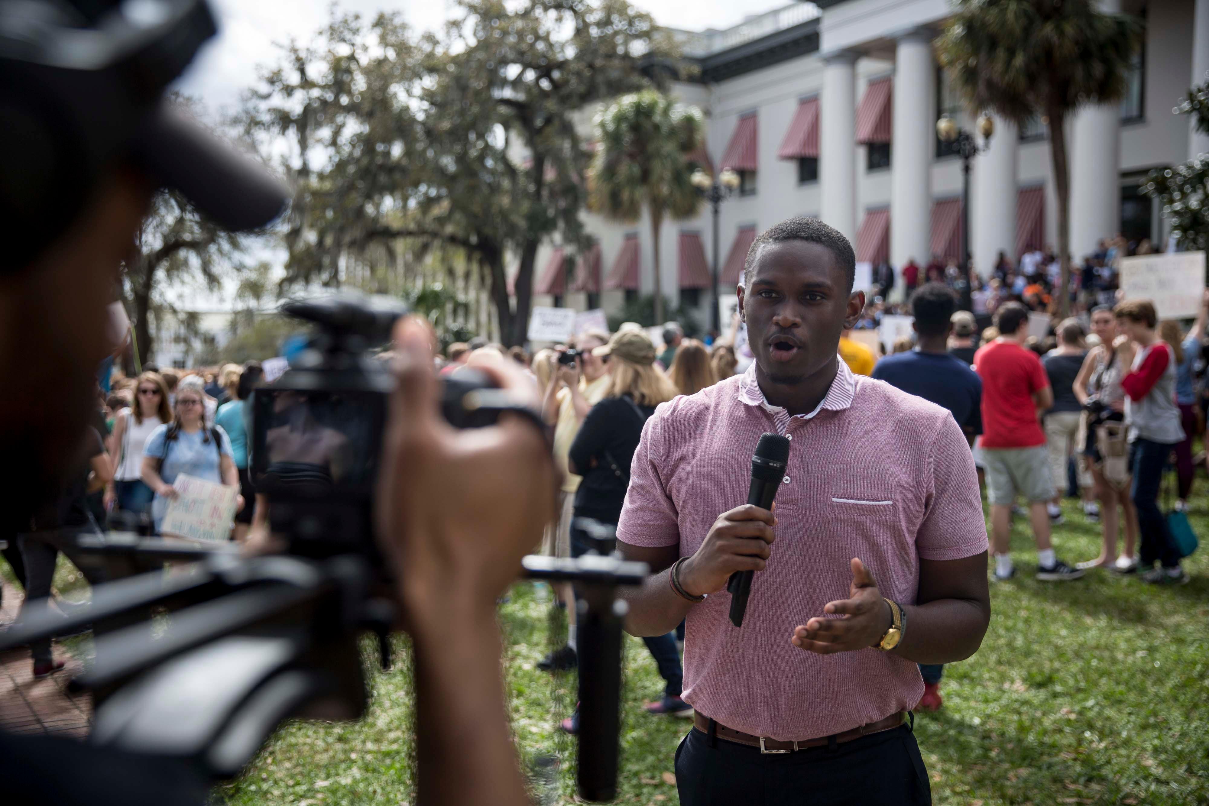 Broadcast Journalism Student interviewing students outside the Florida Capitol building after a march. 