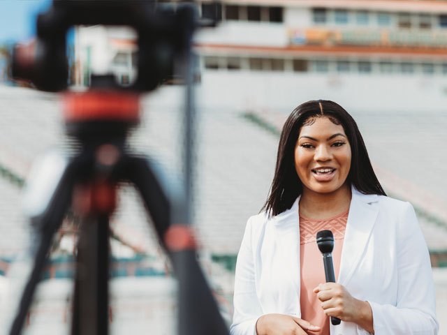 Broadcast journalism student in the field reporting