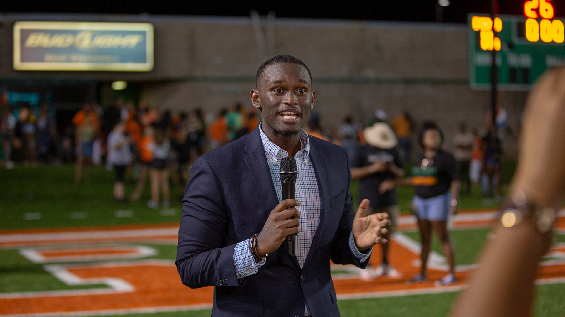 Student reporter on the football field after a game